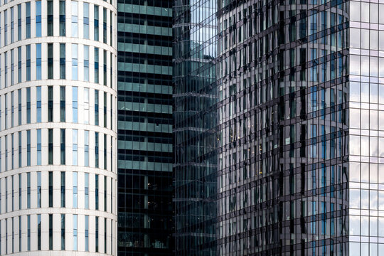 Contrasting facade textures line office towers in Warsaw, Poland, giving corporate architecture and the business district a strong urban identity