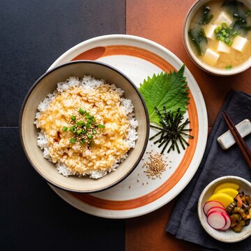 Tamago Kake Gohan (TKG): Steaming Hot Japanese Rice Topped With a Raw Egg and Soy Sauce, Stirred Until Creamy and Often Garnished With Nori, Furikake, or Scallions