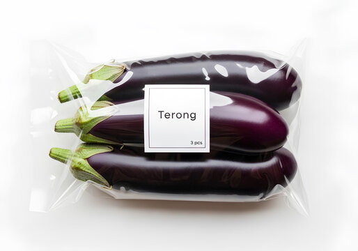 Fresh purple eggplants in plastic wrap packaging isolated on white