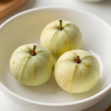Three fresh star apples in a white bowl, healthy eating and tropical fruit concept, natural food ingredient