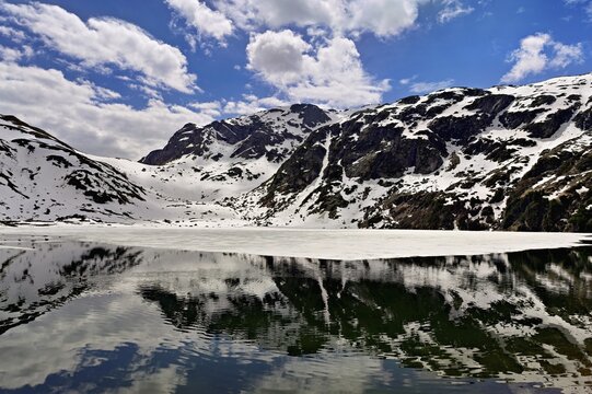 Ice floes float in the half-frozen Upper Murgsee, Murgtal, Canton of St. Gallen, Switzerland