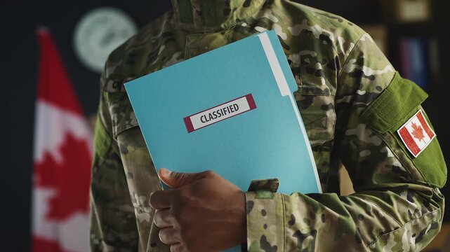 Black Canadian army officer holds classified folder with top secret documents