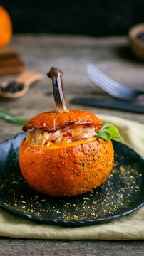 Close up of a gourmet stuffed mushroom appetizer on a rustic wooden surface, featuring rich colors and fresh ingredients, perfect for culinary blogs or entertaining guides