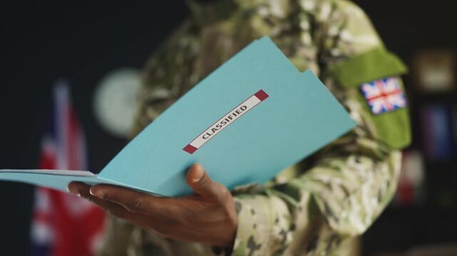 British male soldier photographs classified documents, military espionage