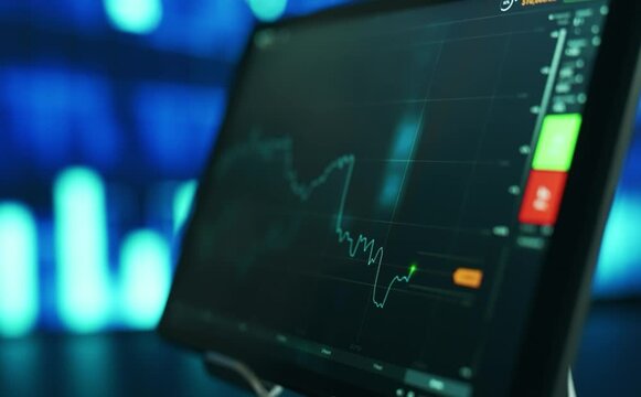 Close up on a digital stock market trading chart with red and green candlesticks showing price fluctuations on a dark screen, financial data analysis