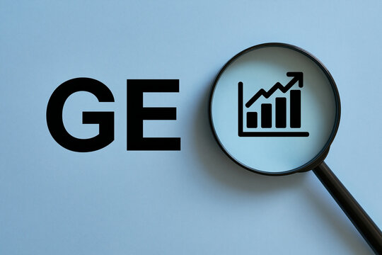 GE letters beside a magnifying glass growth chart. Business theme.