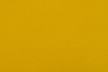 Fototapeta premium Mustard Yellow Textured Paper Background,Macro,Close-up macro shot of a vibrant mustard yellow paper texture background, featuring fine grain and natural pattern details for creative design projects.