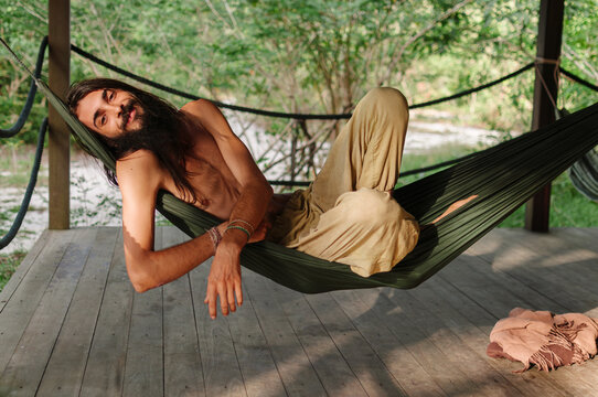 Relaxed man resting in hammock in tropical nature