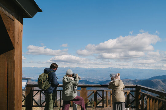 Family at mountain observation deck.