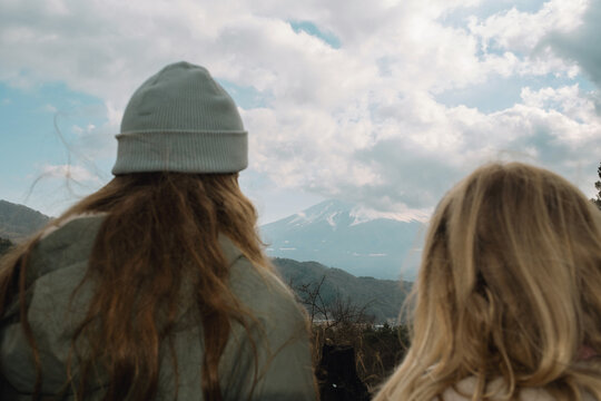 Two girls looking at Mount Fuji.
