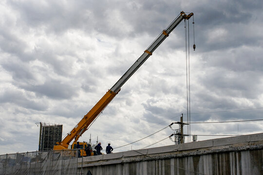 Construction workers working on an expressway demolition on cloudy day