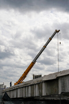 Construction workers working on an expressway demolition on cloudy day
