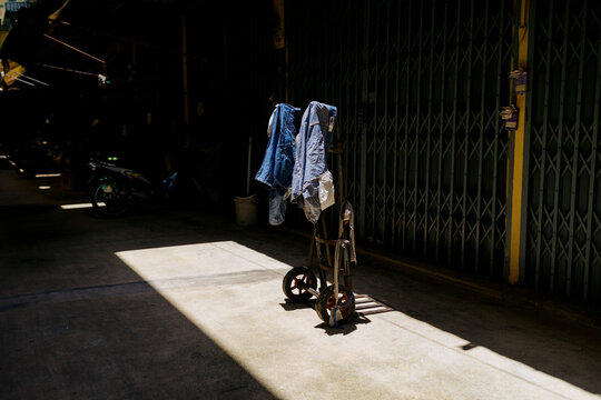 Clothes hanging on a Cart in a market in a town in Thailand during day
