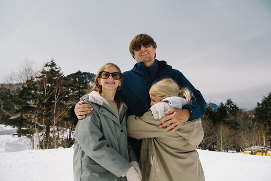 Happy family in snowy landscape.