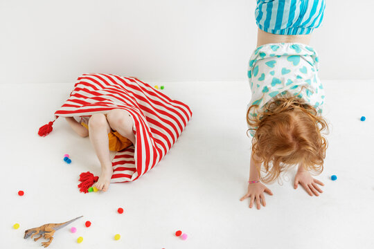 Children play together on a colorful mattress