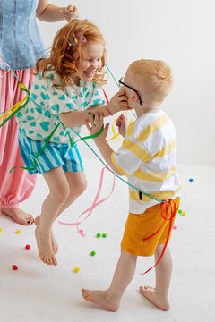 Children play with colorful ribbons.