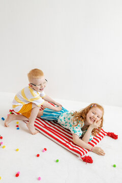 Children play together on a colorful mattress