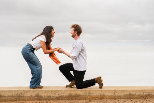 couples engagement marriage proposal on one knee 