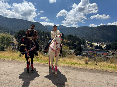 Couple riding horse during vacation