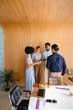 Group Discusses Ideas in Office Setting During Work Hours
