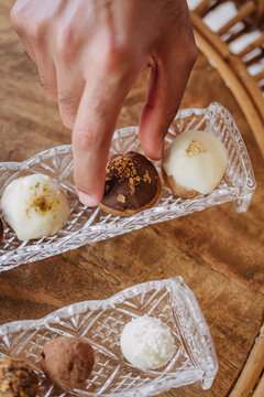 Man taking a chocolate praline