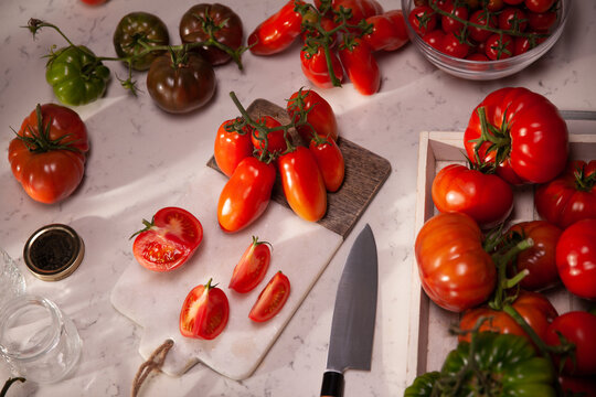 Fresh heirloom tomatoes arranged on kitchen counter ready for slicing
