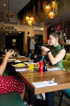 Woman taking photo of food with smartphone