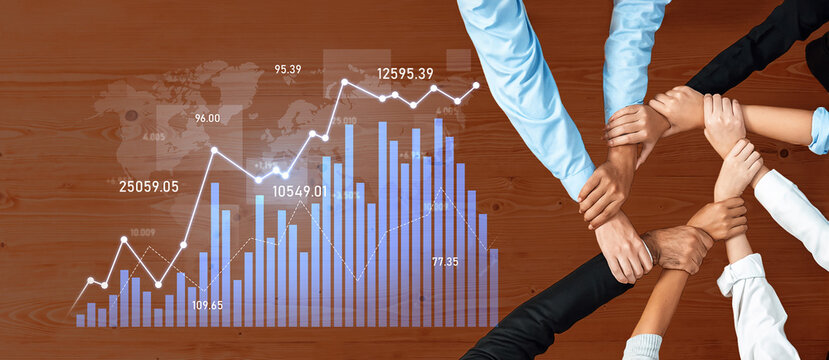 A diverse group of professionals unites their hands in collaboration, with financial graphs symbolizing growth and success in a dynamic business environment. Scalp