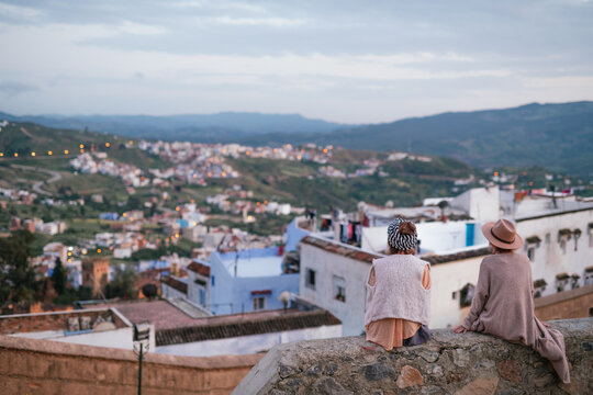 Two Women Tourists Watching the Sunset Over Chefchaouen City