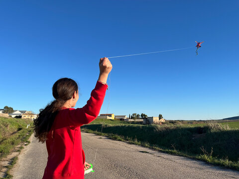 flying kite over blue sky