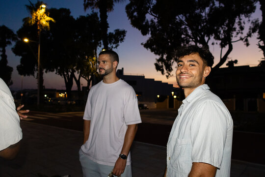 Portrait of young men on a summer evening promenade in Benicassim