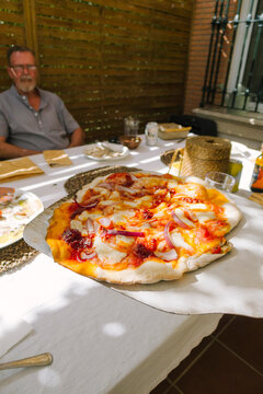 Pizza Served Outdoors During a Meal 