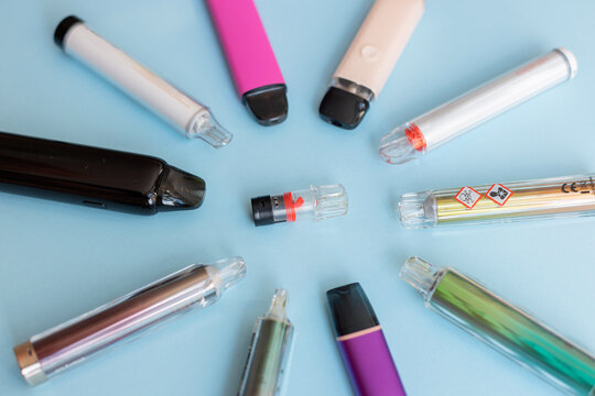 Circular pattern of e-cigarettes with clear toxic substance symbols. Emphasizing the dangers of vaping.
