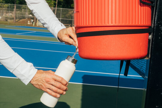 Refilling reusable bottle at tennis court