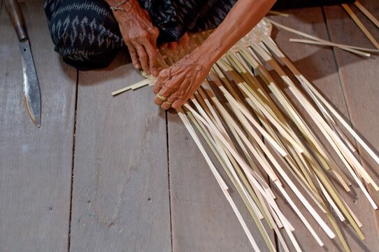Close-Up of Elderly Woman's Hands Weaving Bamboo Fan