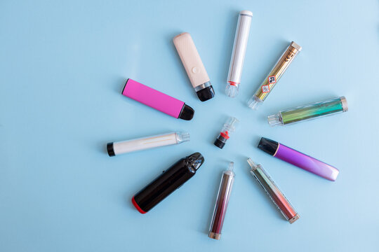Vaping gadgets of all styles gathered around a central warning. A visualization of potential respiratory damage.