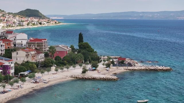 Beach Facility And Swimmers Along The Podstrana Coast, Croatia