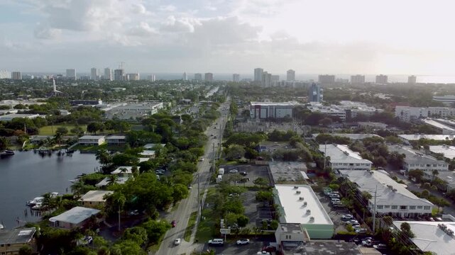 Aerial view drone video of a residential neighborhood, houses near lake with pools, cars, boats, bridges, tropical plants, palm trees, Pompano Beach Fl USA Miami beach, sunny day