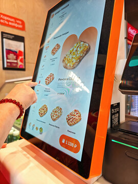 Self-service terminal (kiosk) at a &lsquo;Dodo Pizza&rsquo; restaurant, with the Roman pizzas section displayed on the screen: Abakan, Russia - August 10, 2026
