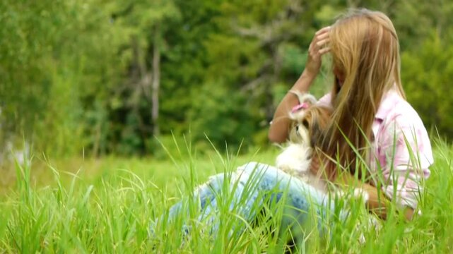 Young beautiful woman holds small fluffy dog