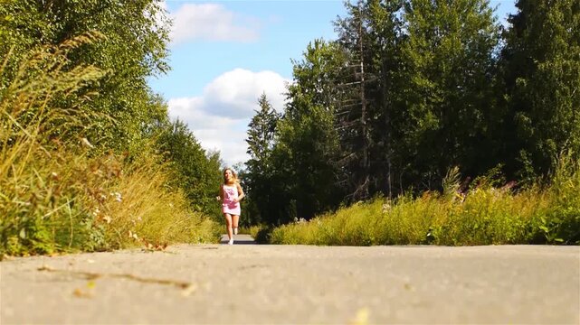 Beautiful young woman running on road in park