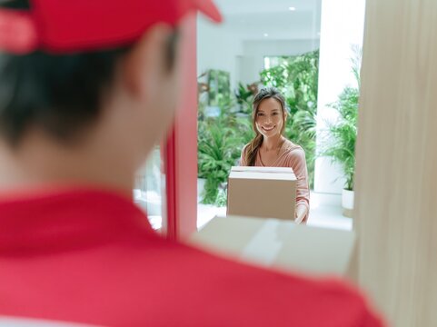 Courier Delivers Joyful Package to Modern Home Setting