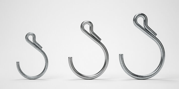 Three metal r-clips or cotter pins of different sizes on white background