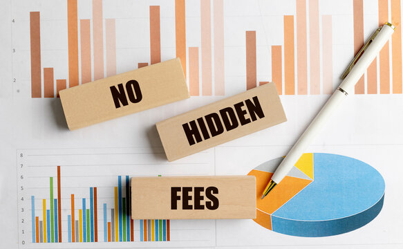 No hidden fees concept with wooden blocks, financial charts and pen, representing transparent pricing, costs, finance, business