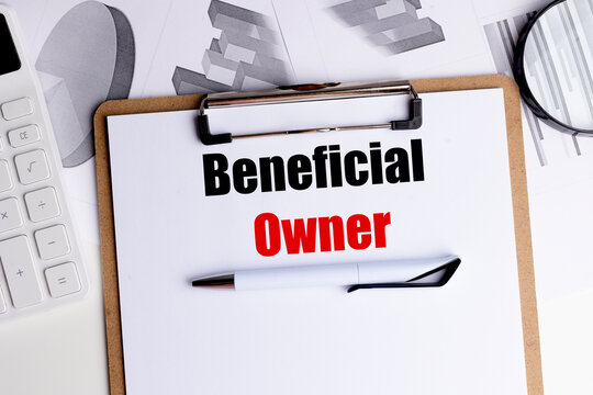 Beneficial owner concept displayed on clipboard with pen, calculator and financial charts representing business ownership and corporate compliance