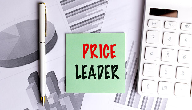 Price leader concept displayed on green note with financial charts, calculator and pen representing competitive pricing strategy and market leadership