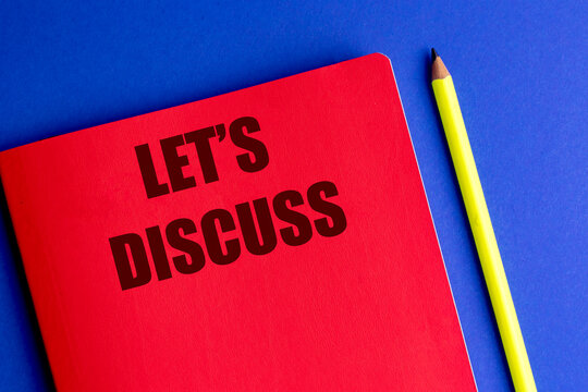 Red notebook with let's discuss text and yellow pencil on blue background, representing communication, conversation, meeting