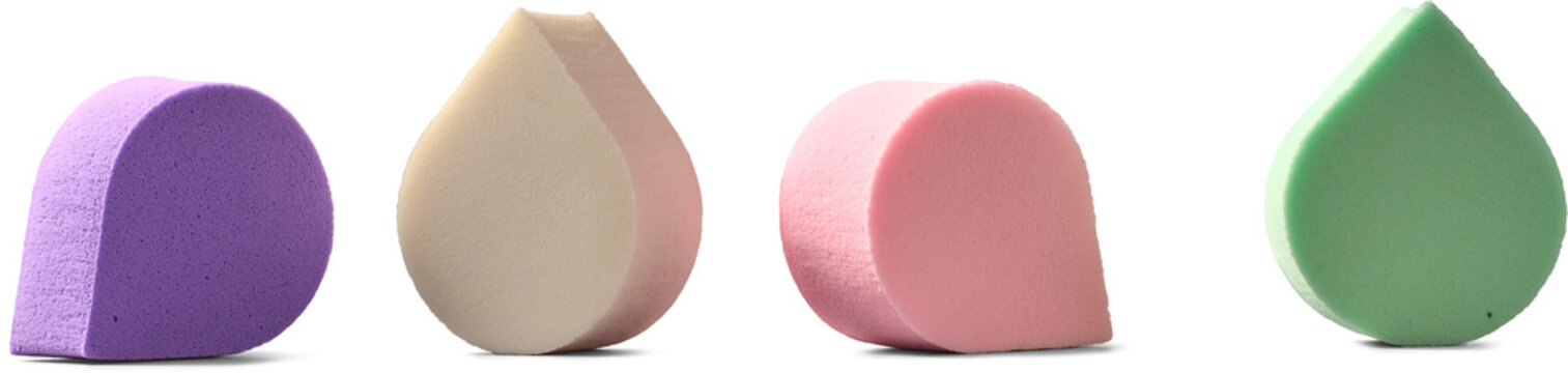 colorful makeup sponges isolated white background, purple beige pink and green cosmetic blenders in close-up view