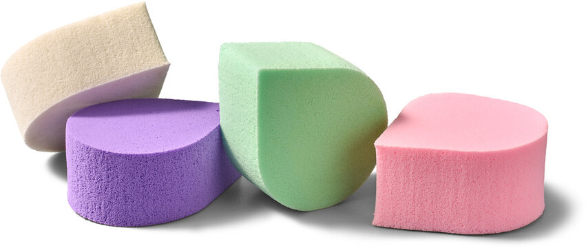 colorful pastel makeup sponges isolated white background, pile of soft foam cosmetic blenders in close-up view