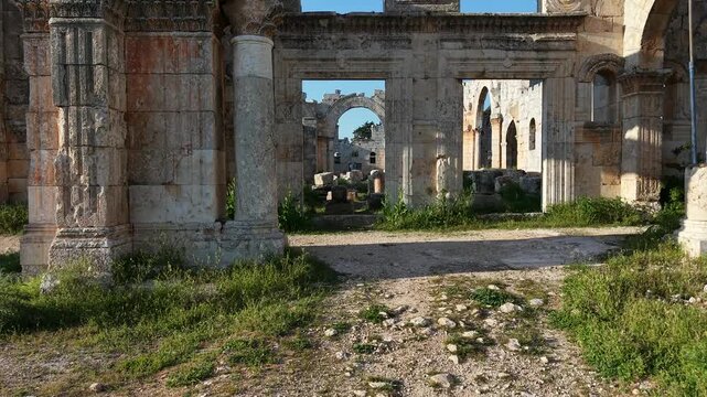 Aerial drone view of the historic ruins of Qal'at Semaan in Syria. Ancient stone architecture and arches at the Church of Saint Simeon Stylites. Famous archaeological site.